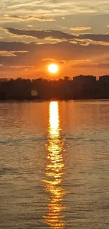 Beautiful sunset over calm water with golden reflections.