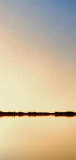 Golden sunset reflecting over calm water, creating a peaceful, serene scene.