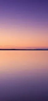 Tranquil purple sunset over calm waters, perfect for phone wallpaper.