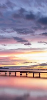 Mobile wallpaper of a serene sunset over a tranquil pier.