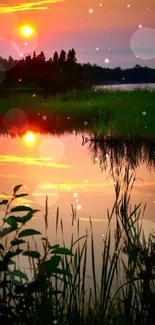 Serene sunset reflects over a tranquil lake with lush greenery.