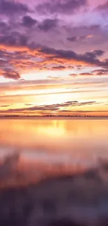 Tranquil sunset reflection over calm water with vibrant purple and orange hues.