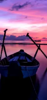 Calm lake at sunset with purple and pink skies, and a silhouetted boat.