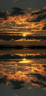 Orange sunset reflection over calm water with silhouette landscape.