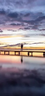 Serene sunset reflecting over calm waters at a quiet pier.