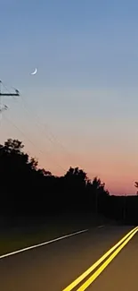 A serene road under a vibrant sunset sky with a crescent moon.