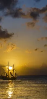 Sailboat sailing in a sunset with golden sky and calm ocean.