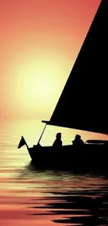 Silhouette of a sailboat against a vibrant sunset on calm waters.