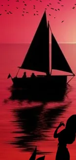 Sailboat silhouette on red sunset background.