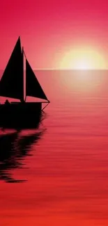 Silhouette of sailboat at sunset over calm ocean.