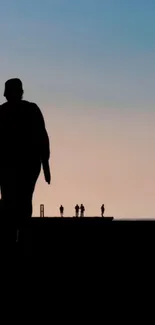 Silhouettes at sunset with a tranquil sky.