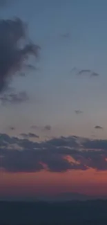 Dark blue sunset sky with clouds and vibrant horizon.