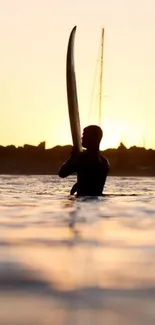 Silhouette of a surfer at sunset in calming golden hues.