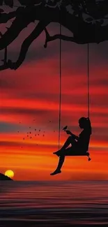 Silhouette swing at sunset over ocean waters.