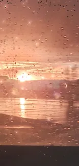 Sunset through a rain-speckled window creating a serene mobile wallpaper.