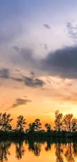 Sunset reflecting on calm water with trees silhouetted against sky.