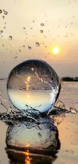 Water drop reflecting sunset on calm water surface.