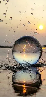 A reflective sphere on water with sunset background.