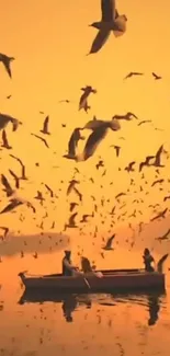 Silhouetted boat on calm lake during vibrant sunset with flock of birds in the sky.