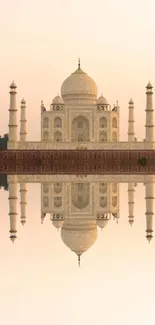 Taj Mahal mirrored on still water creates a tranquil mobile wallpaper.