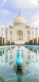 Reflection of Taj Mahal with a serene sky and lush greenery.