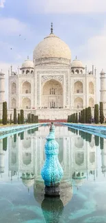 Taj Mahal reflecting in tranquil pools under a soft, blue sky.