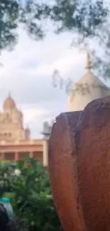 Mobile wallpaper depicting a serene temple garden with lush greenery.