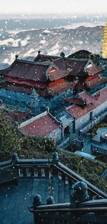 Serene temple amidst snowy mountains and cloudy backdrop.