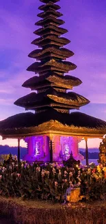 Serene temple at sunset with a vibrant purple sky.