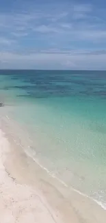 A stunning tropical beach with azure waters and a sandy shore under a clear blue sky.