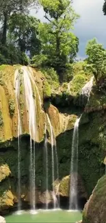 Lush tropical waterfall with vibrant green surroundings.