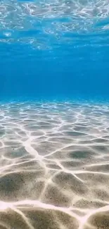 Serene underwater ocean view with sunlit blue waters and gentle ripples.