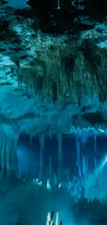 Serene underwater cave with teal blue hues and intricate rock formations.