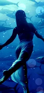 Underwater dancer surrounded by fish in blue hues.