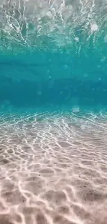 Serene turquoise underwater ocean scene with sunlit sandy floor.