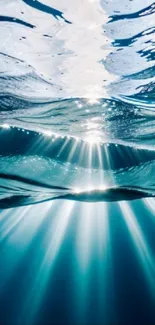 Underwater scene with sunlight rays filtering through blue ocean waters.