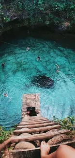 Aerial view of people swimming in a tropical lagoon with a wooden ladder.