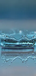 Close-up of a blue water droplet splash creating ripples.