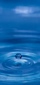 Serene blue water droplet creating ripples.