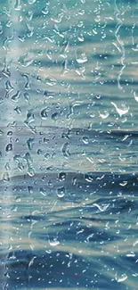 Raindrops on glass with ocean waves in background.