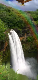 Waterfall with rainbow over lush greenery and sky background.