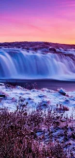 Beautiful waterfall against a vivid sunset sky creating a serene natural scene.