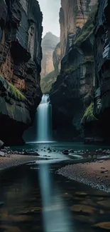 Majestic waterfall within dark canyon walls in peaceful nature setting.