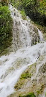 Beautiful waterfall over mossy rocks in nature.