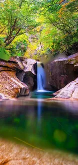 Serene waterfall amidst lush green forest, tranquil mobile wallpaper.