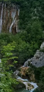 Serene waterfall cascading through lush green forest landscape.