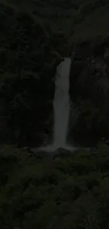 Tranquil waterfall in lush green forest wallpaper.