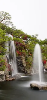 Serene waterfall in a lush green garden with fountain spray.