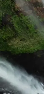 Serene waterfall cascading over lush greenery in nature.