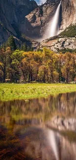 Waterfall and autumn trees reflected in a serene meadow.